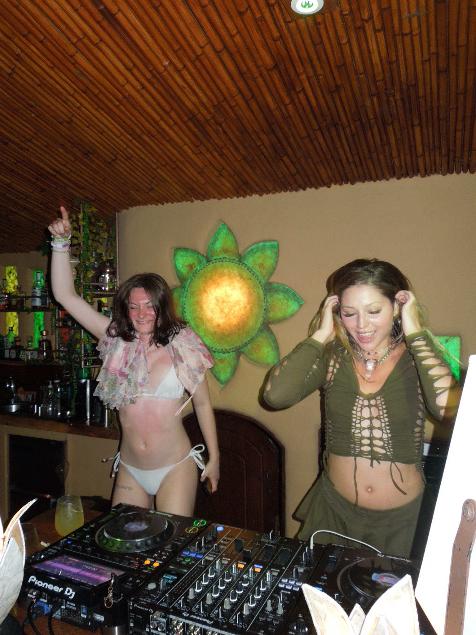 Friends behind the DJ booth at Selva