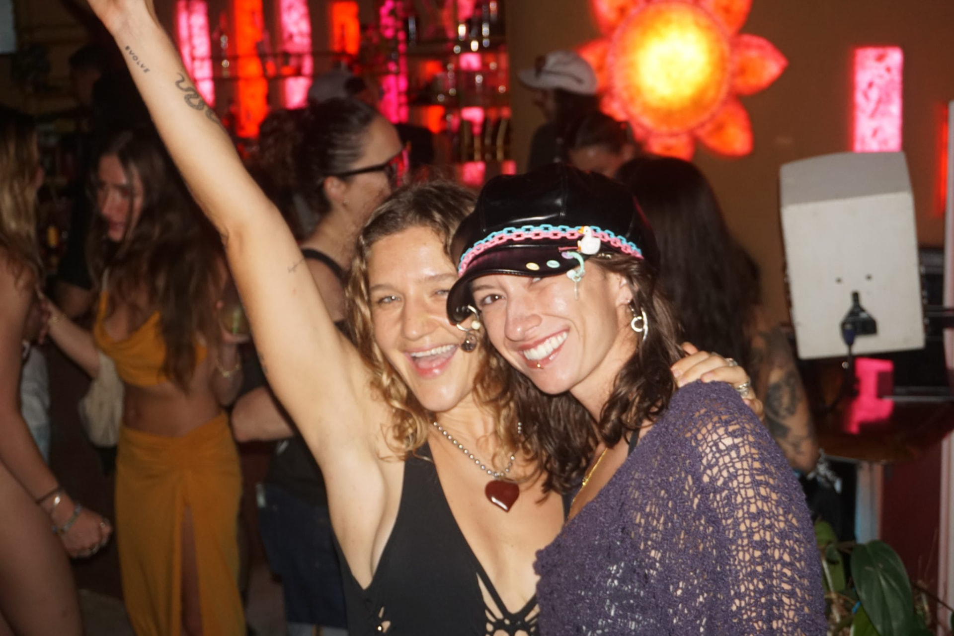 Two friends smiling together on the dance floor