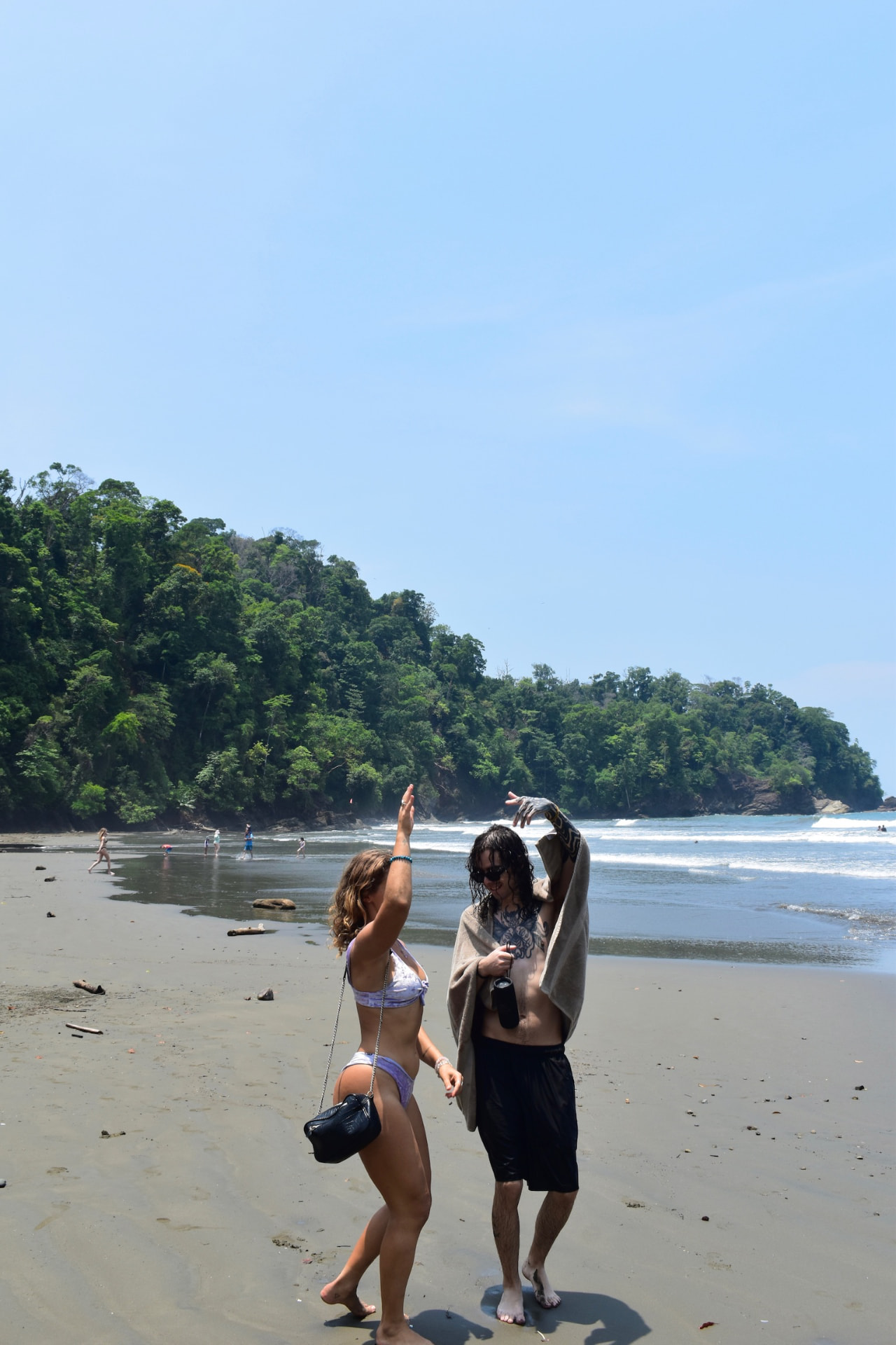 Two friends dancing together on the Costa Rica beach