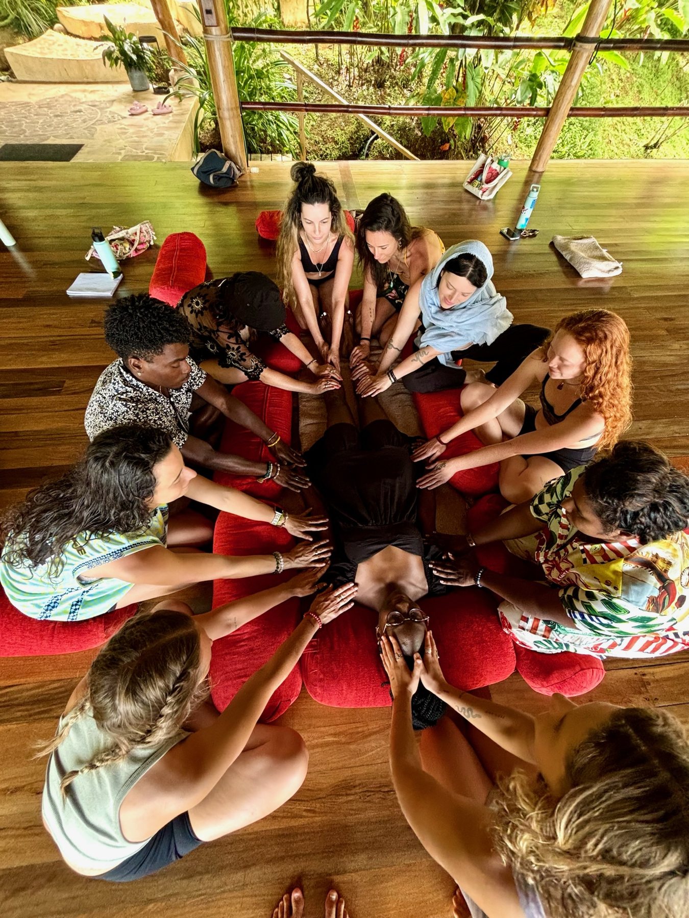 Hands joined in the centre of a ceremony circle