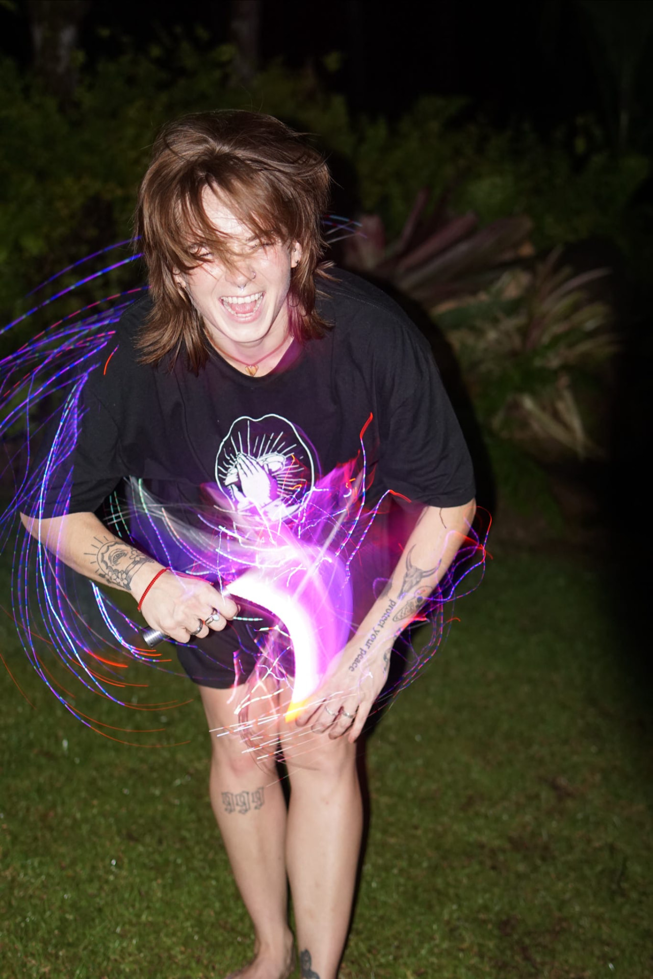Laughing while spinning an LED light whip at night