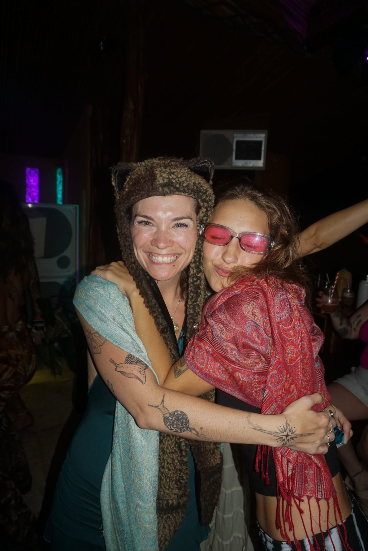 Two friends hugging at the night party