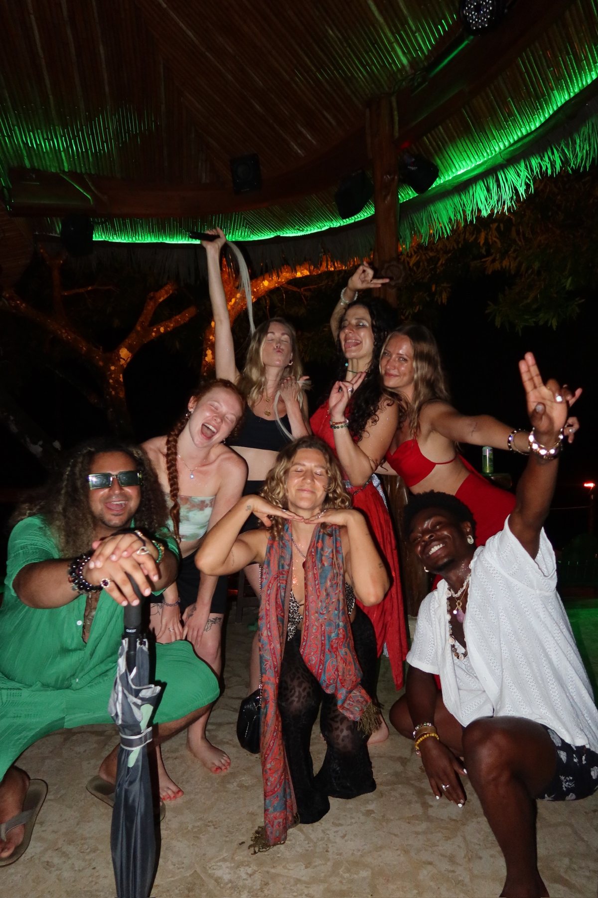 Friends celebrating together under the palapa lights