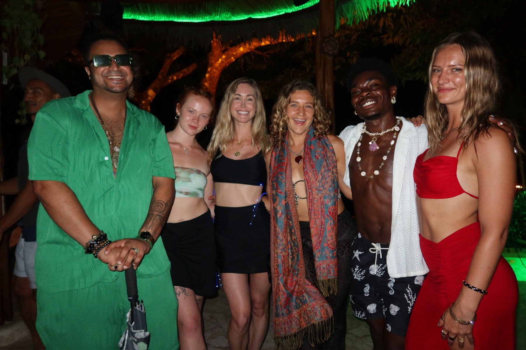 Friends celebrating together under the palapa lights