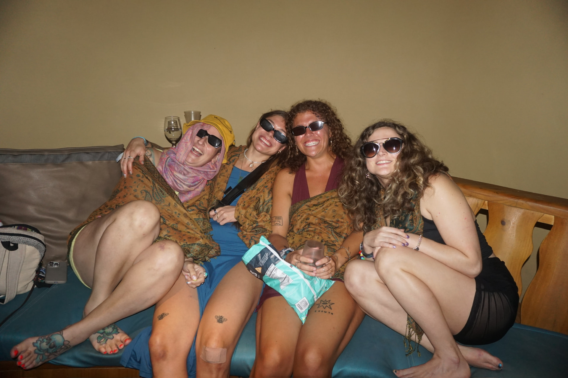 Four friends laughing together on a couch at the retreat
