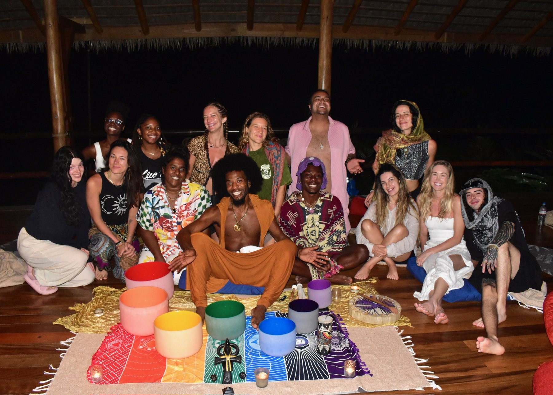 The full group gathered around sound bowls for a candlelit ceremony in the shala