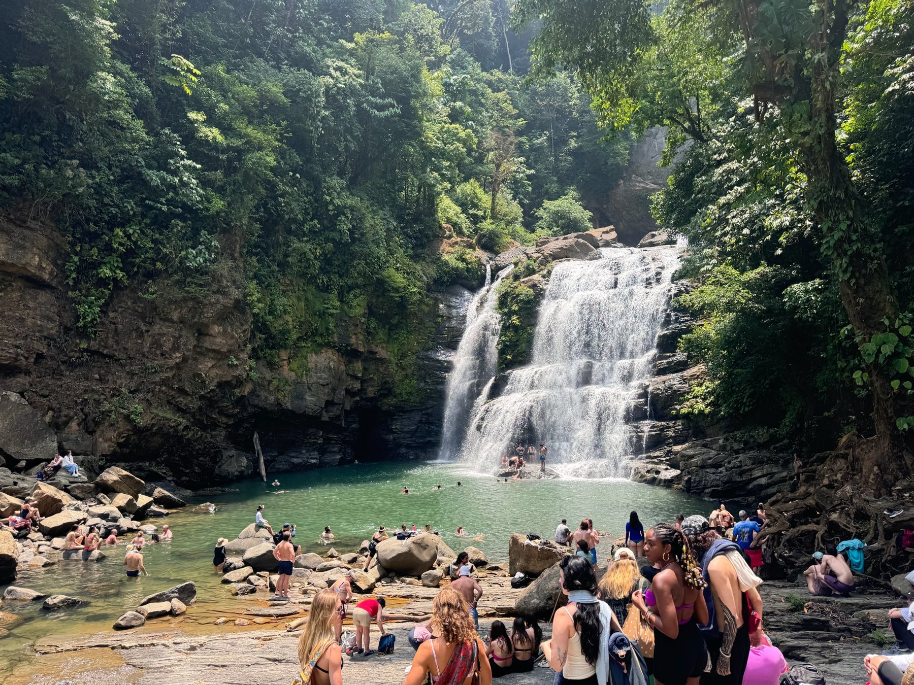 The group at the base of a jungle waterfall