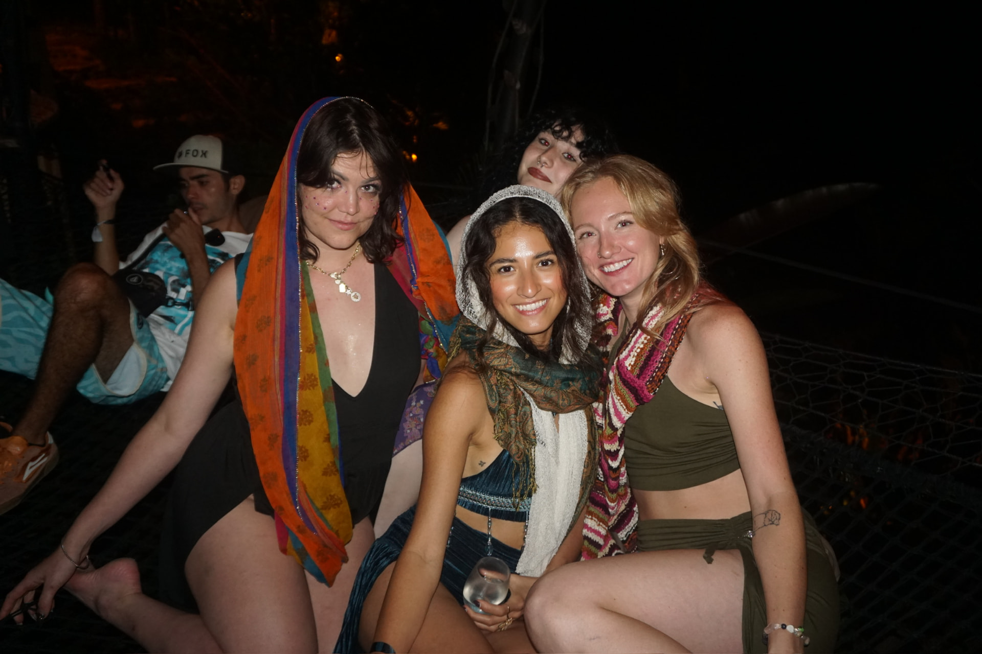 Friends piled onto the hammock nets late at night