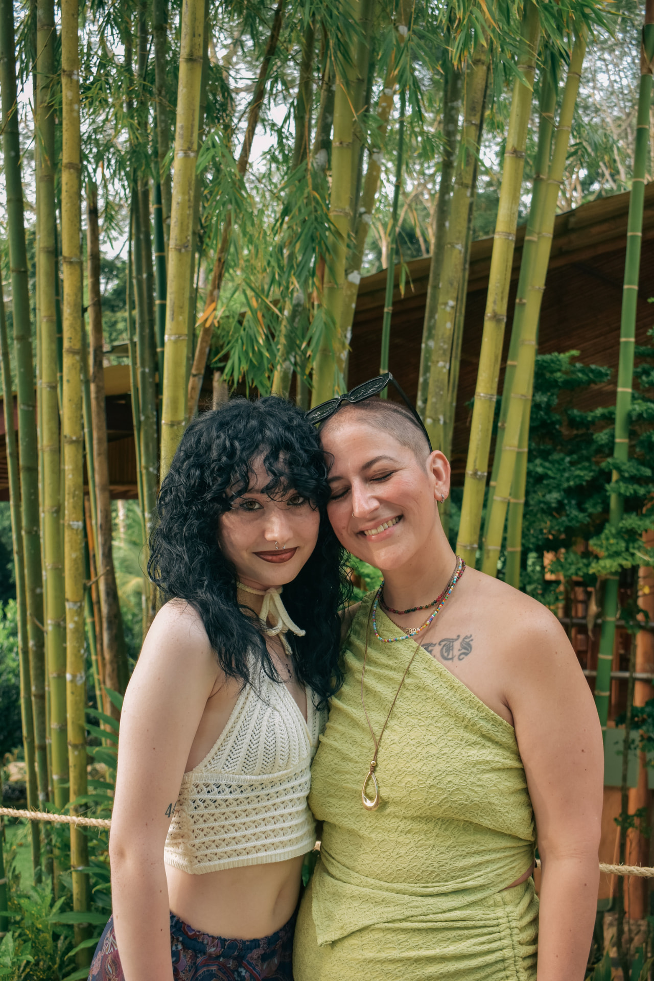 Two friends cheek to cheek in front of the bamboo grove