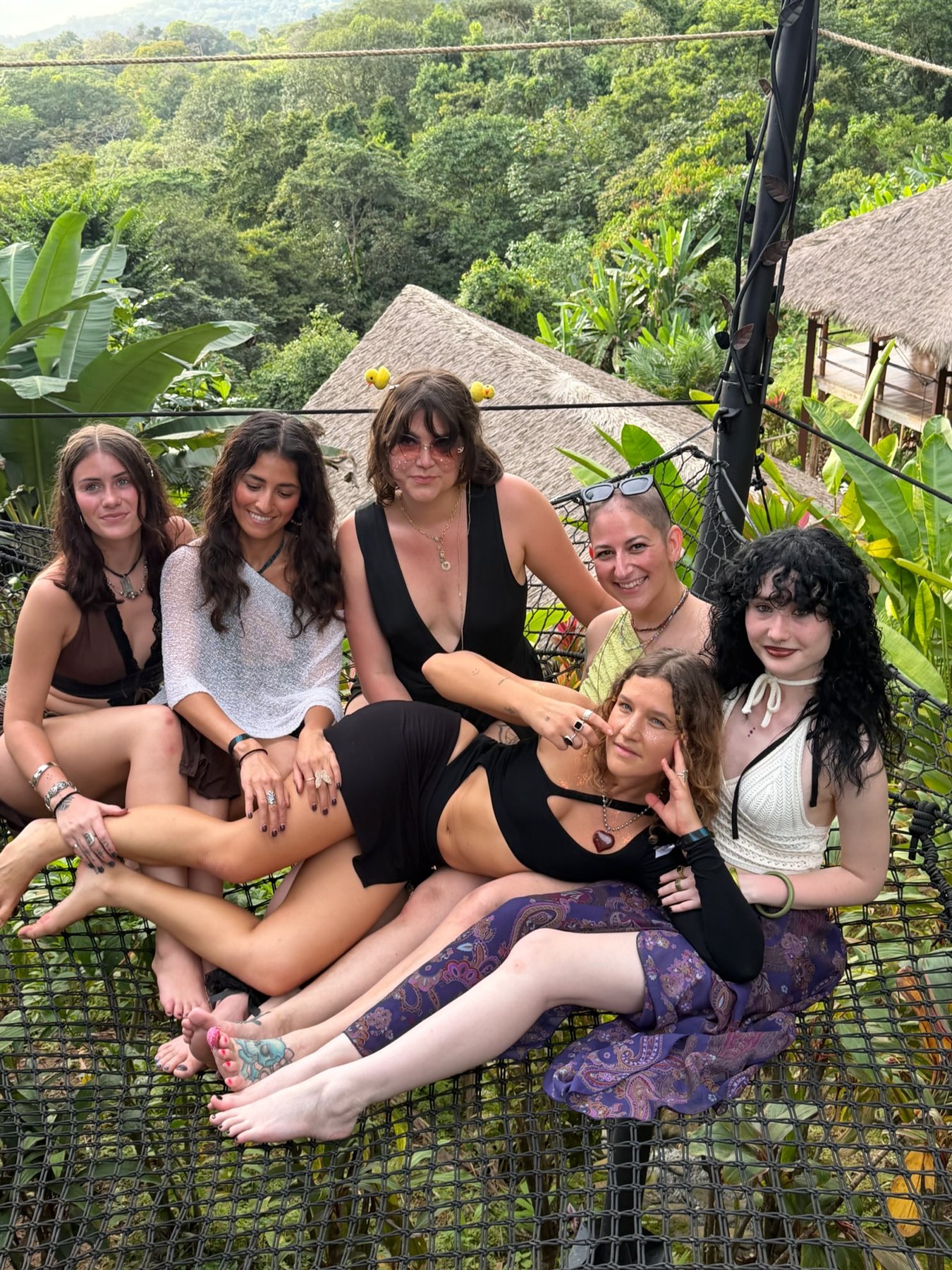 Friends piled onto the hammock nets above the jungle