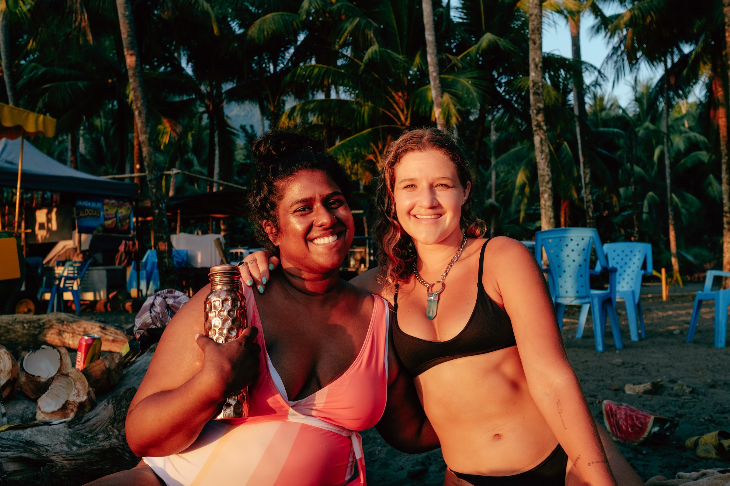 Friends laughing on the beach under the palms