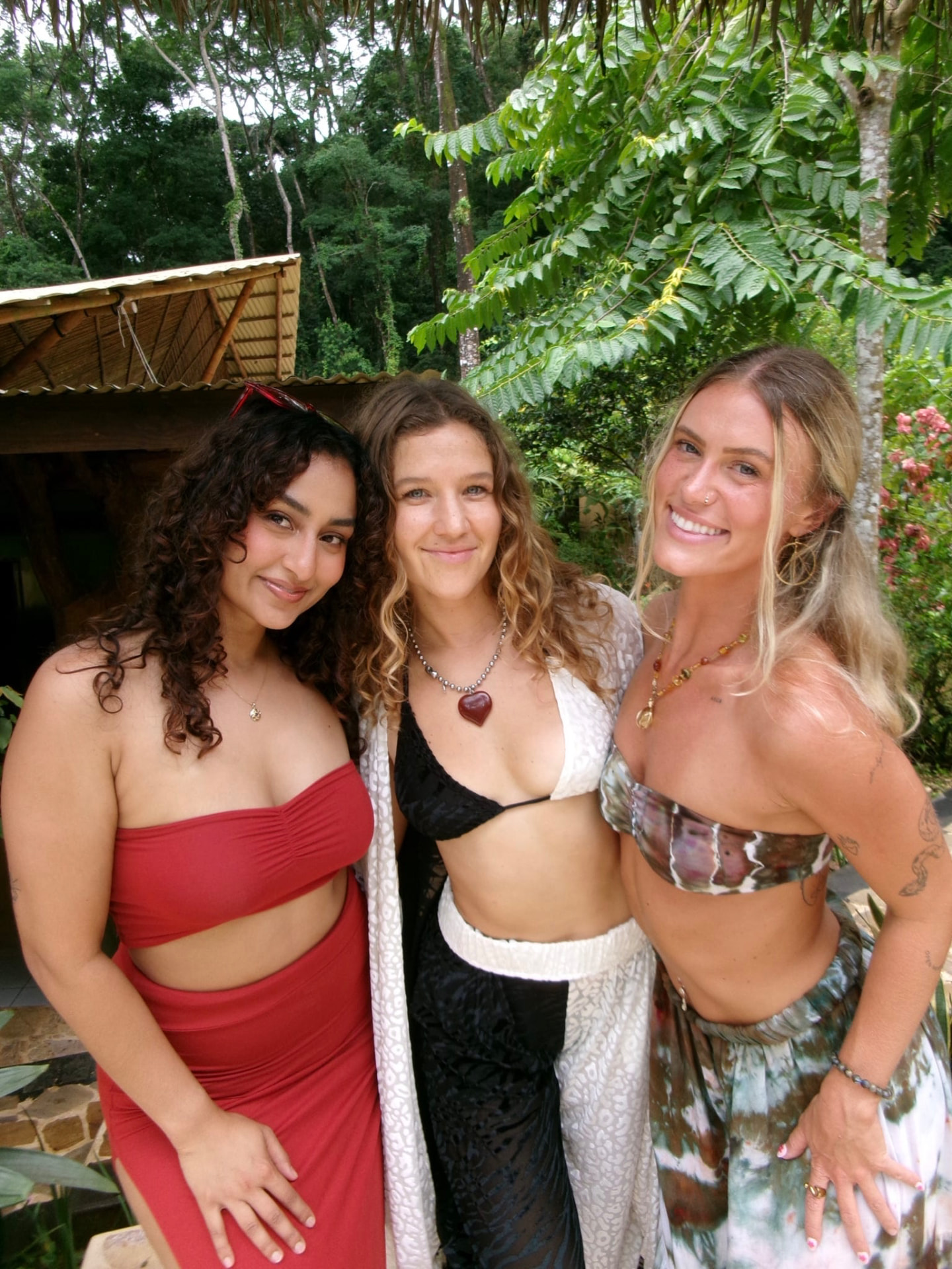 Three friends smiling together in the jungle at Selva Armonia