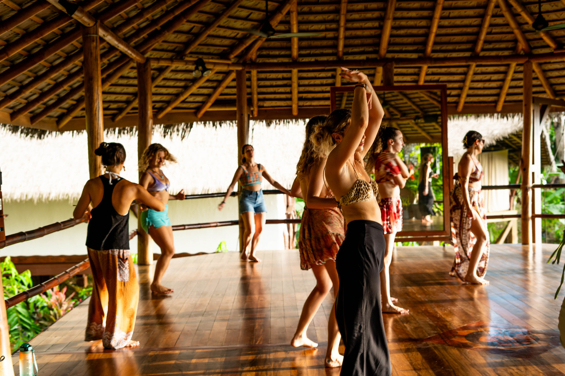 Wide shot of the group moving together in the shala