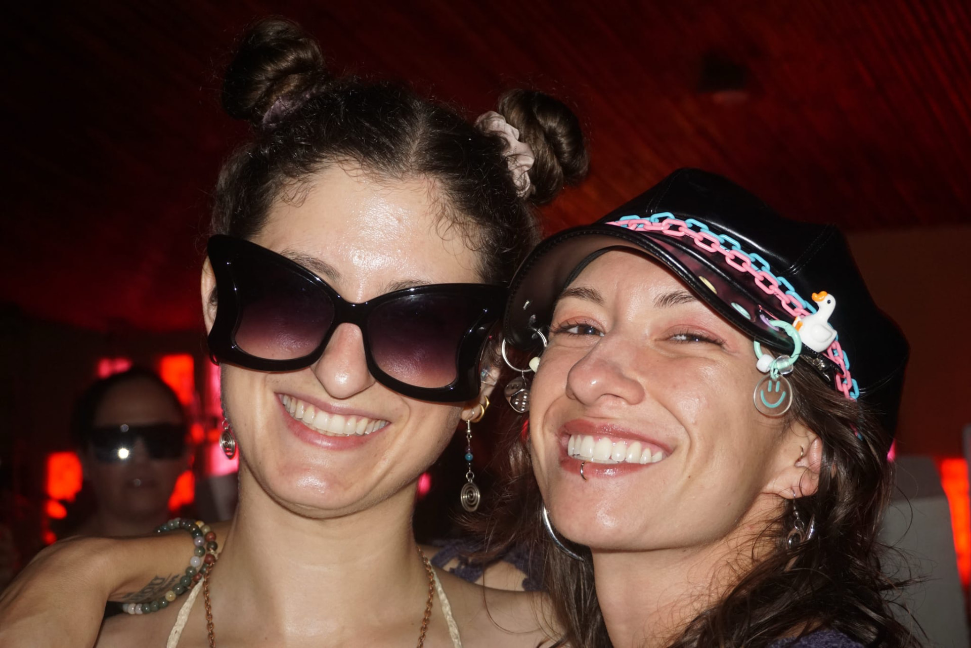 Two friends in playful accessories at the night party