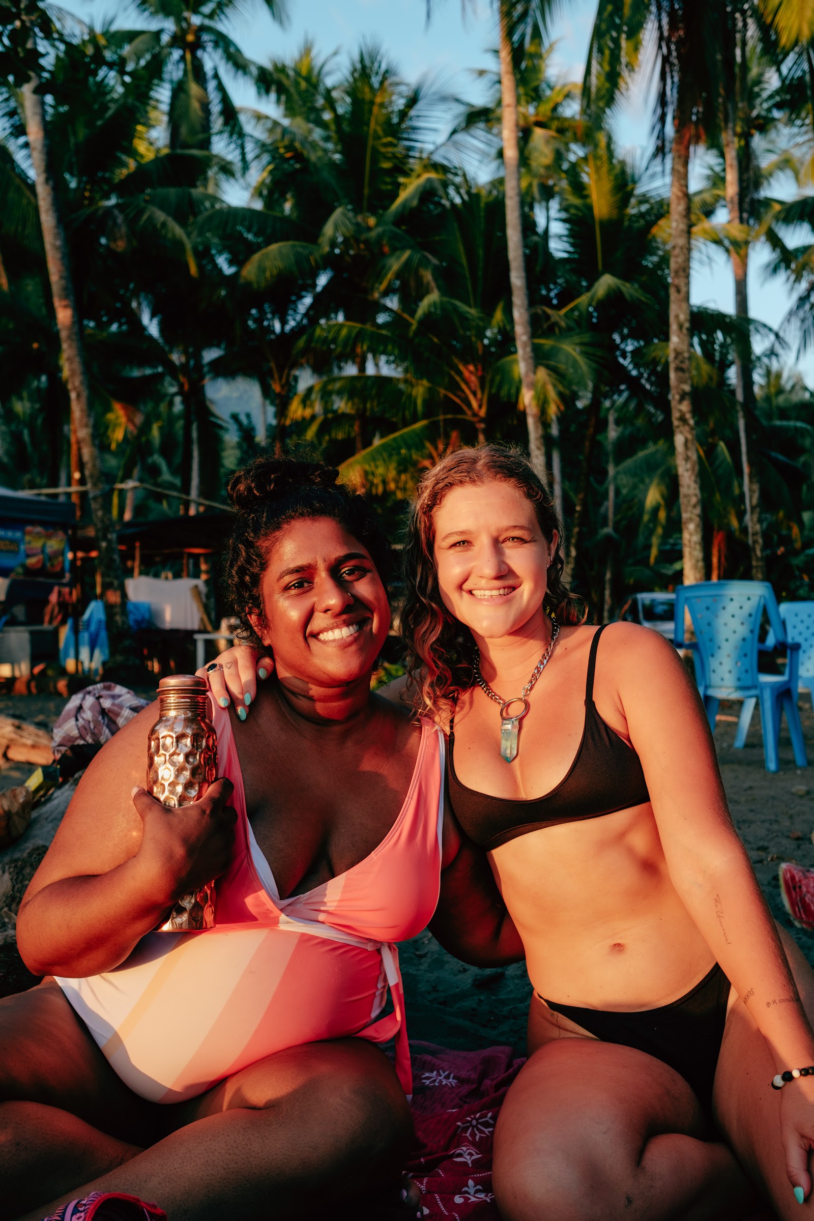 Two friends laughing on the beach excursion under the palms