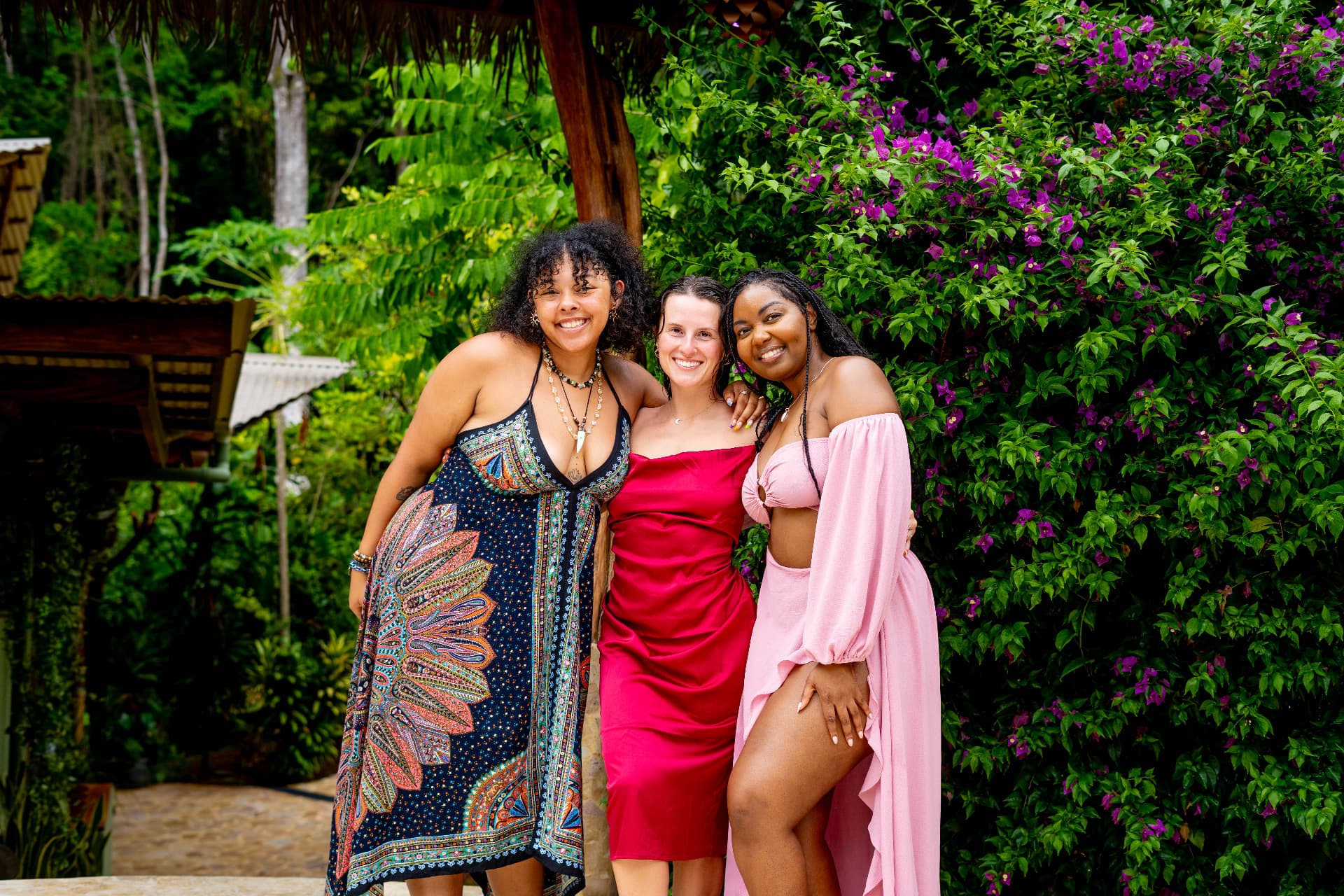 Three friends dressed up in front of the bougainvillea at Selva Armonia