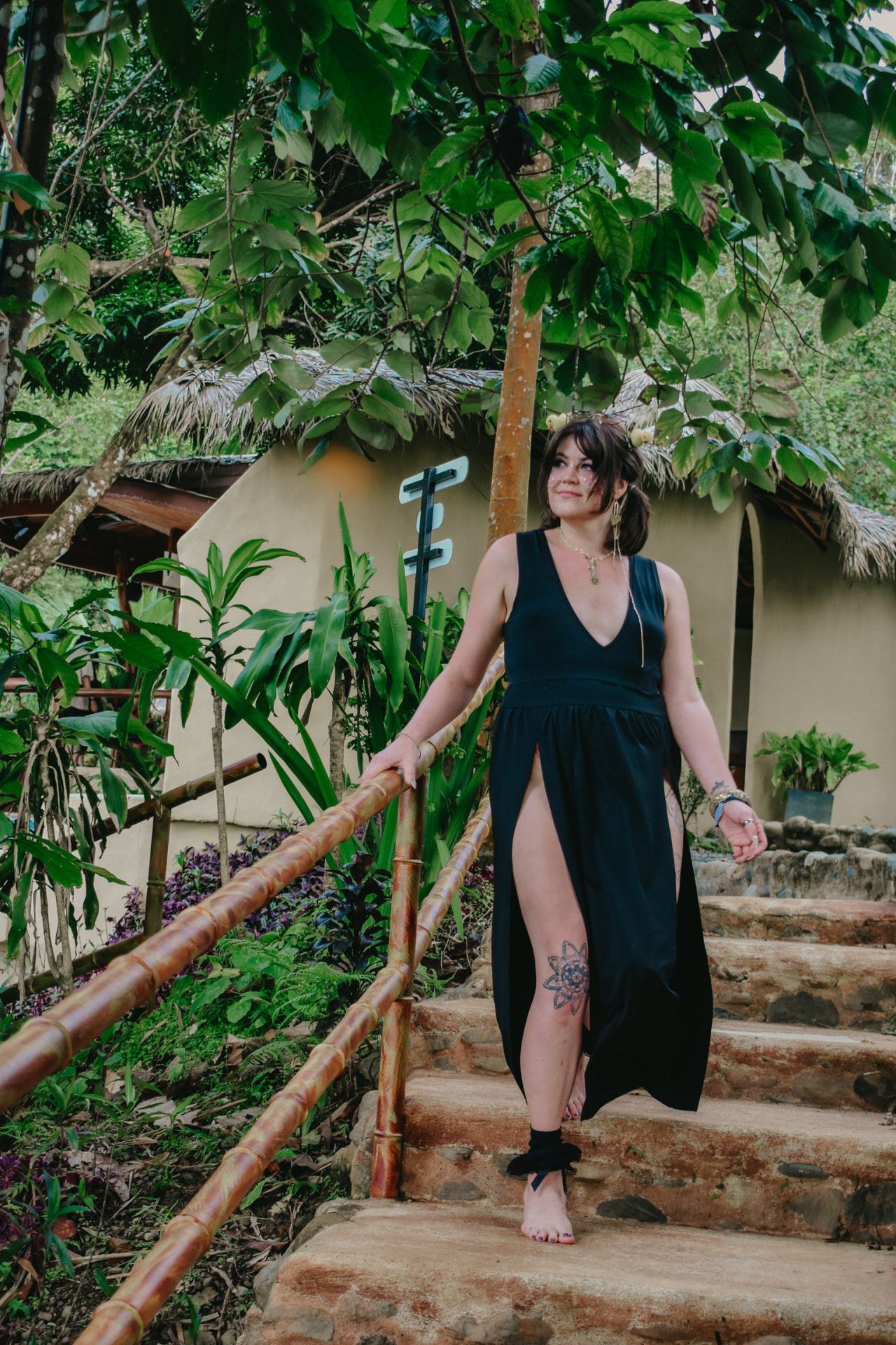 Guest in a black dress walking down the stone steps at Selva