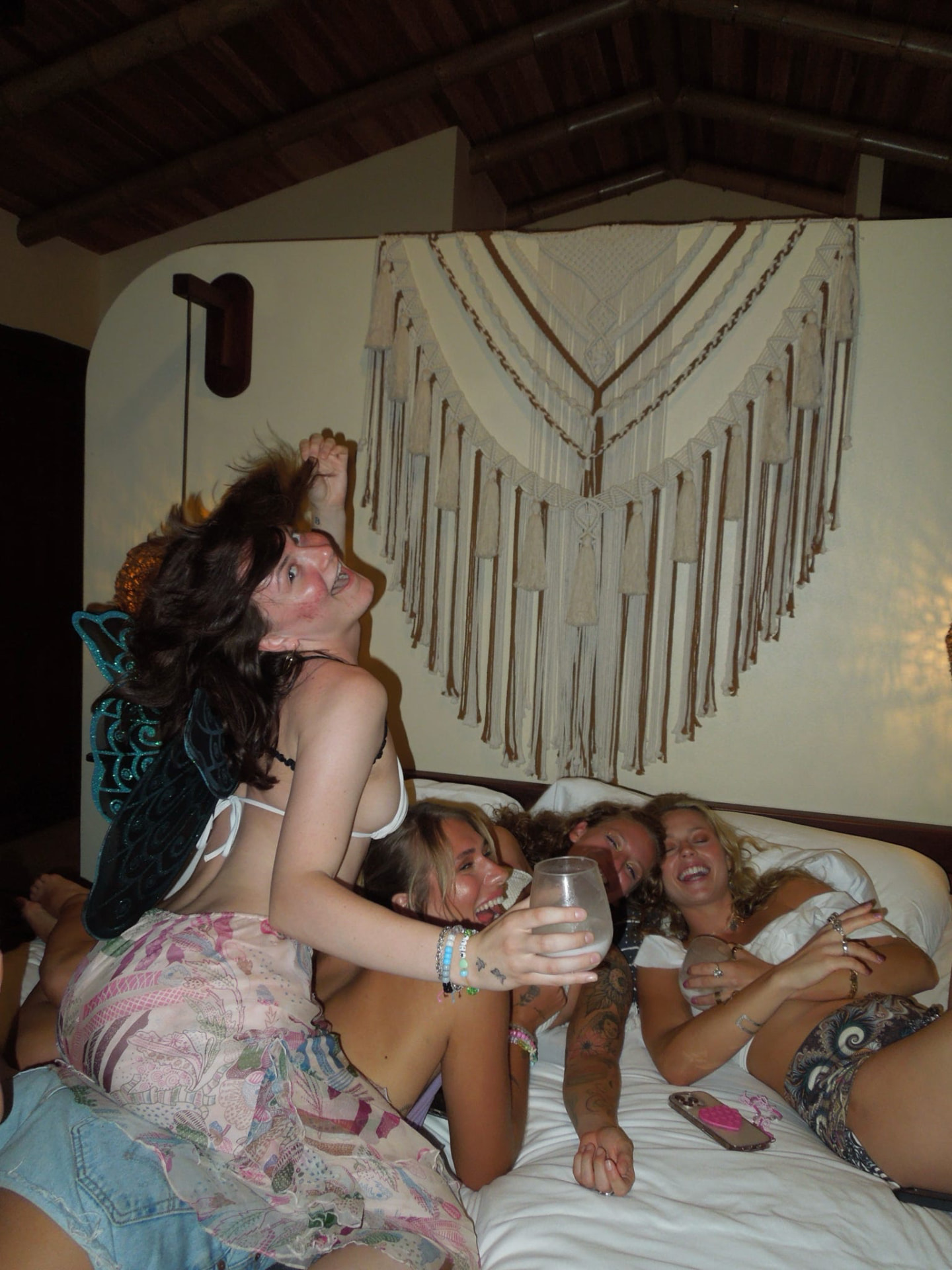 Friends laughing together in the bungalow before the party