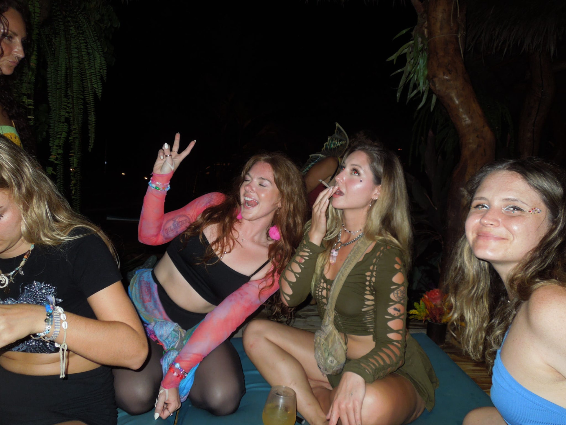 The crew hanging out together on the daybeds at the night party