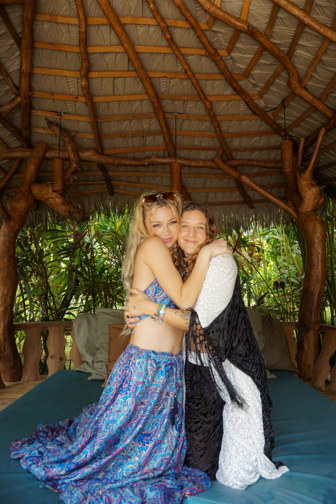 Two friends hugging under the palapa