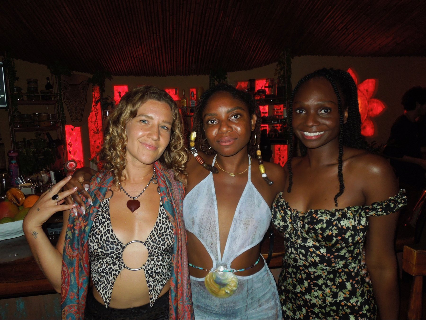 Friends together on the dancefloor with drinks in hand