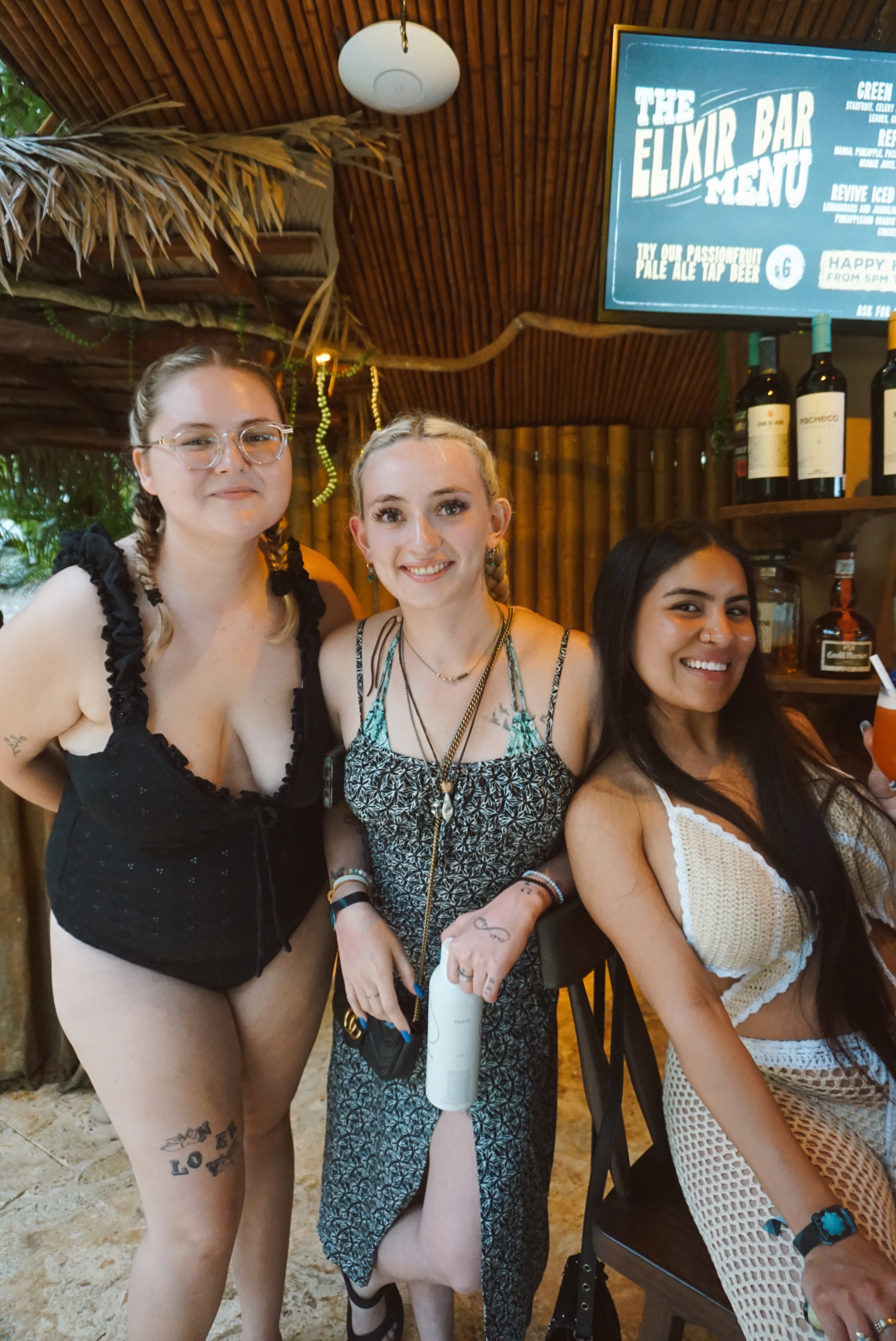 Three friends posing together at the Elixir Bar