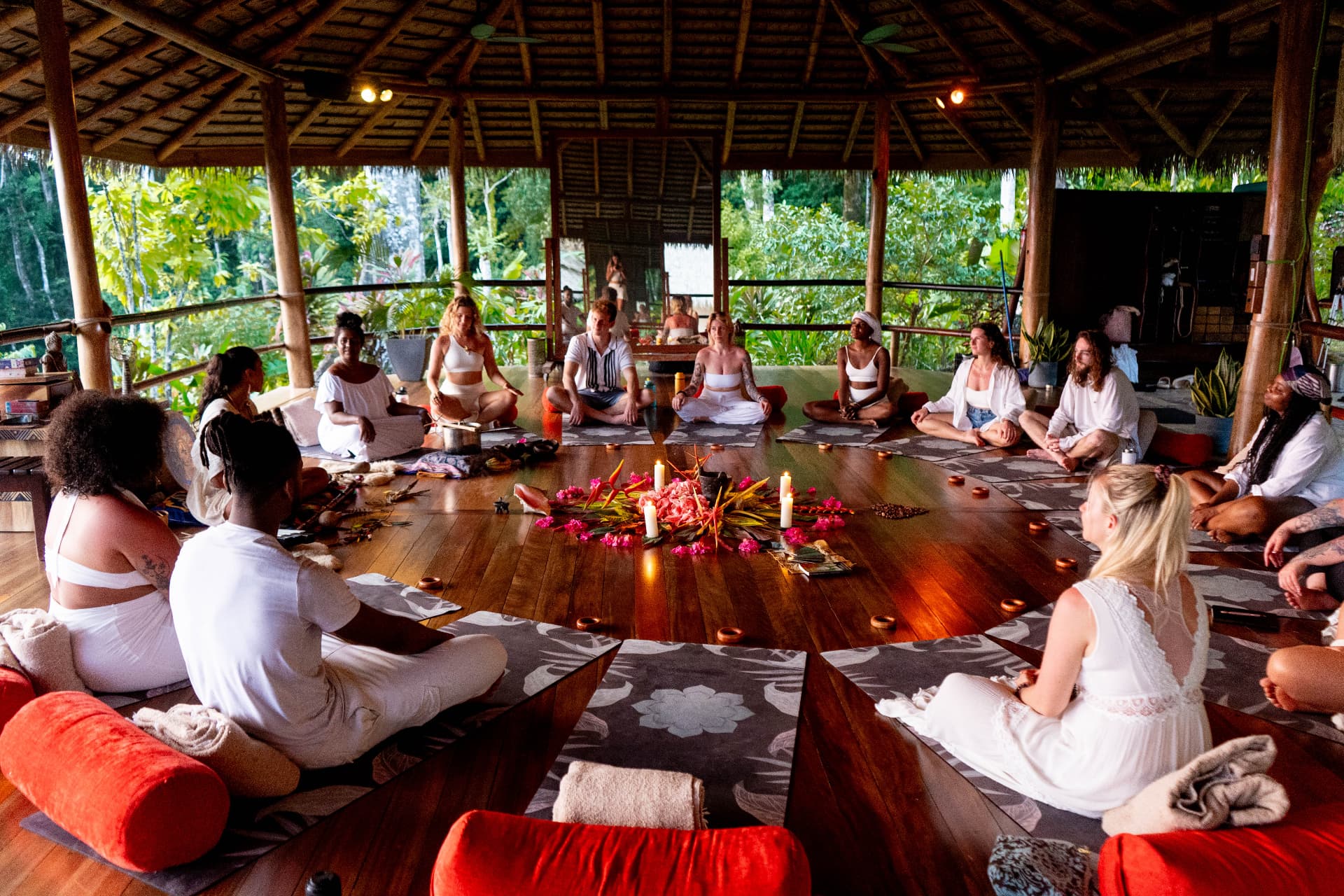 Cacao ceremony circle with guests seated in white in the shala