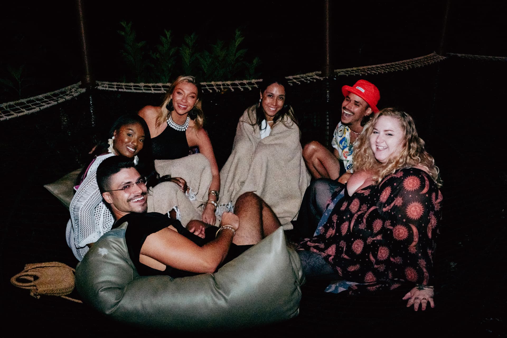The crew wrapped in blankets together on the nets at night