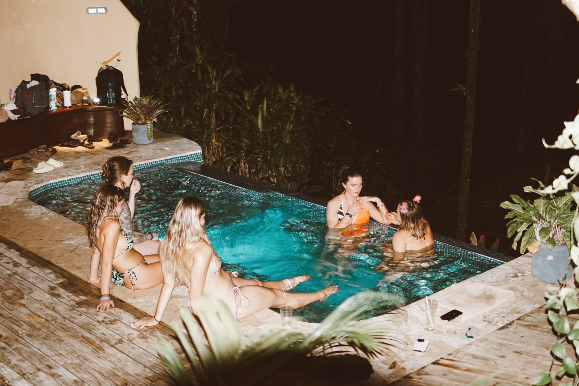 Guests hanging out in the plunge pool late at night