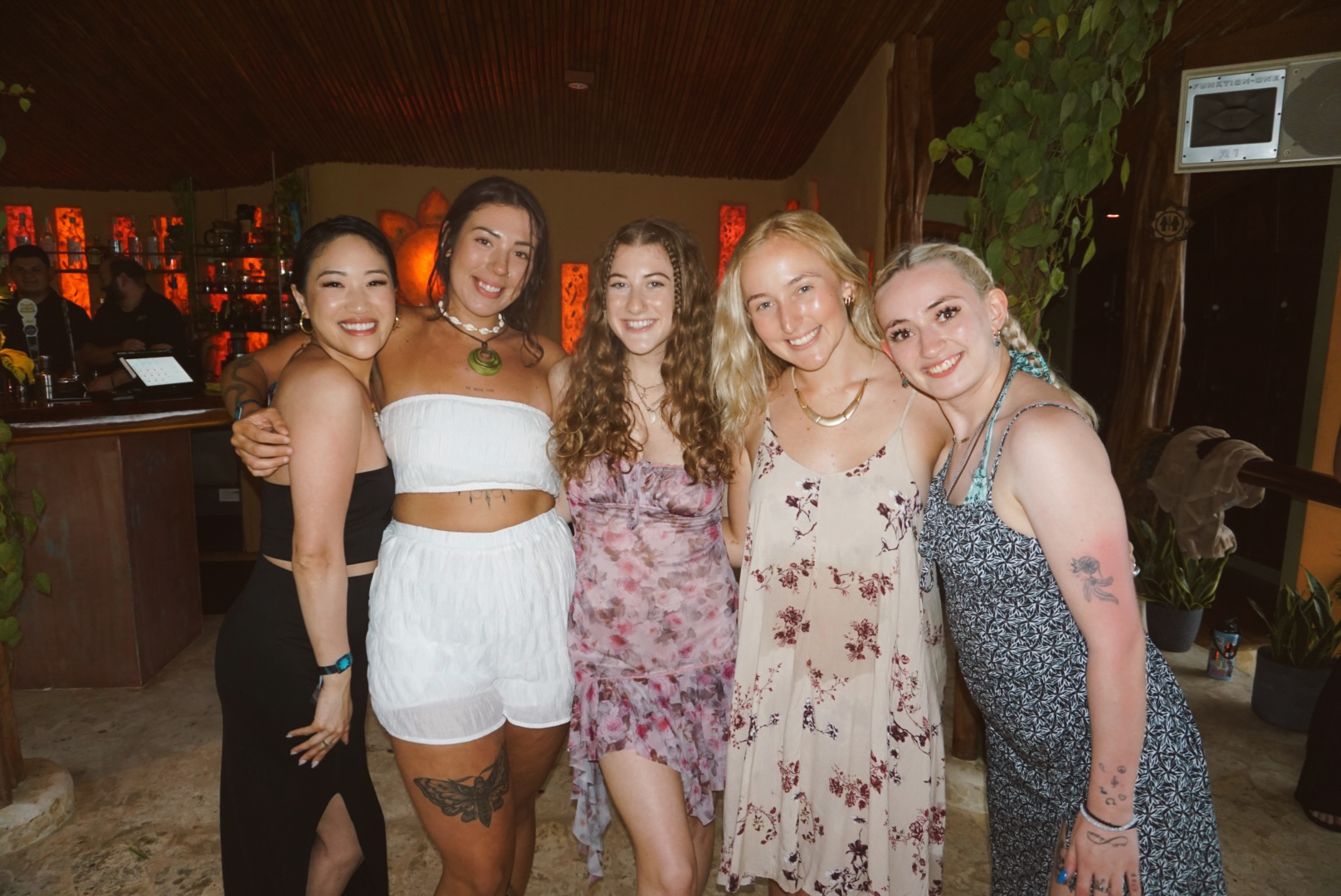 Five friends arm in arm at the Elixir Bar