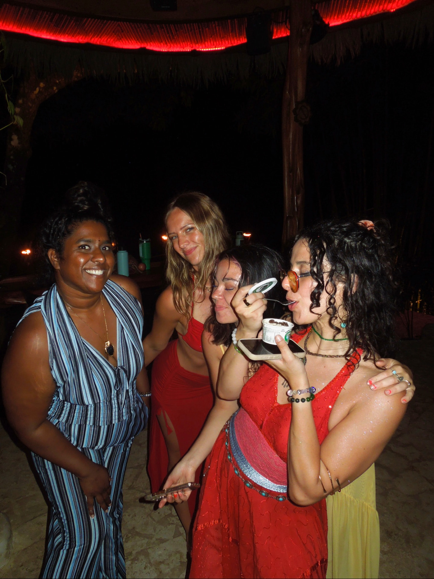 Four friends sharing dessert at the night party