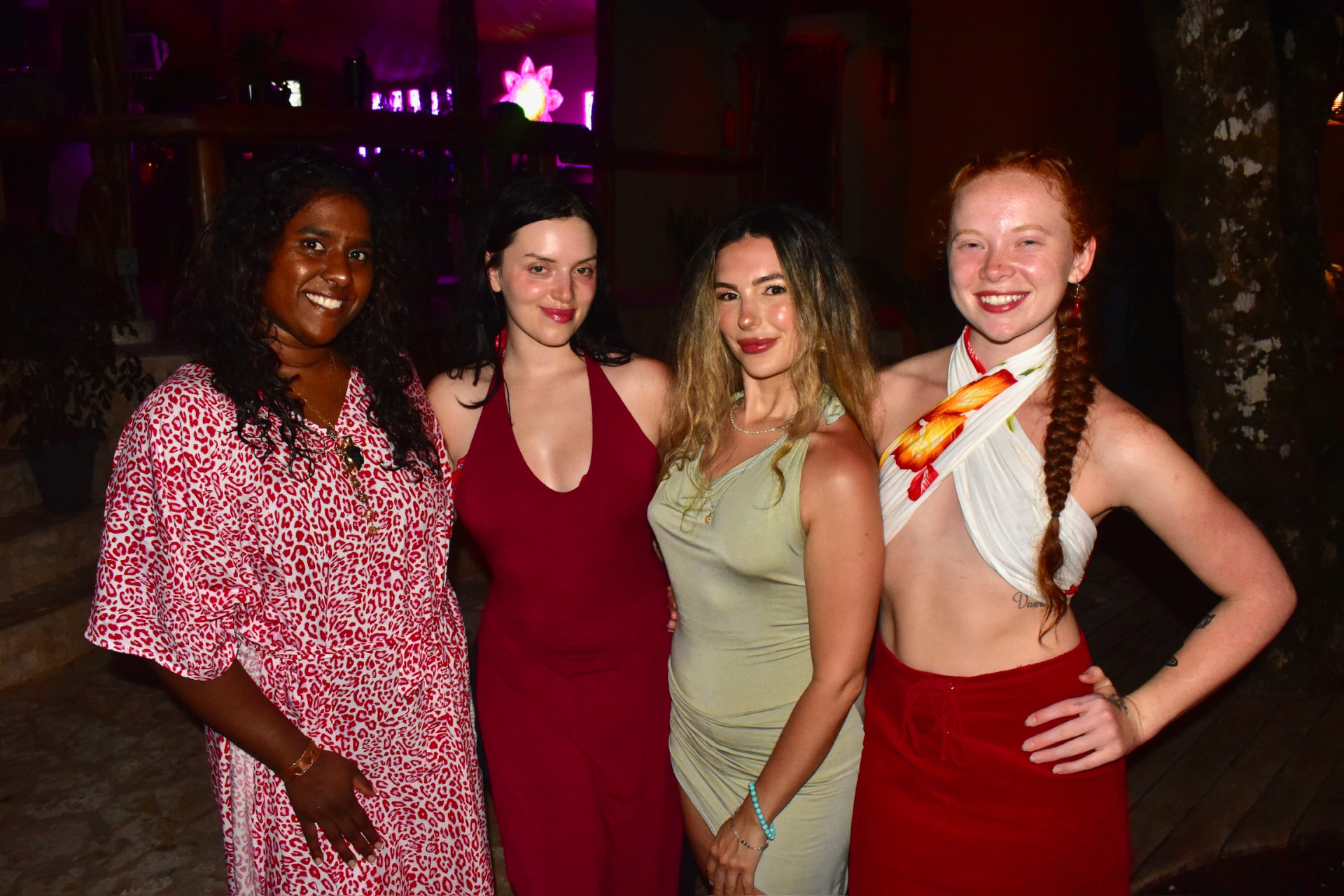 Four friends smiling together at the jungle party