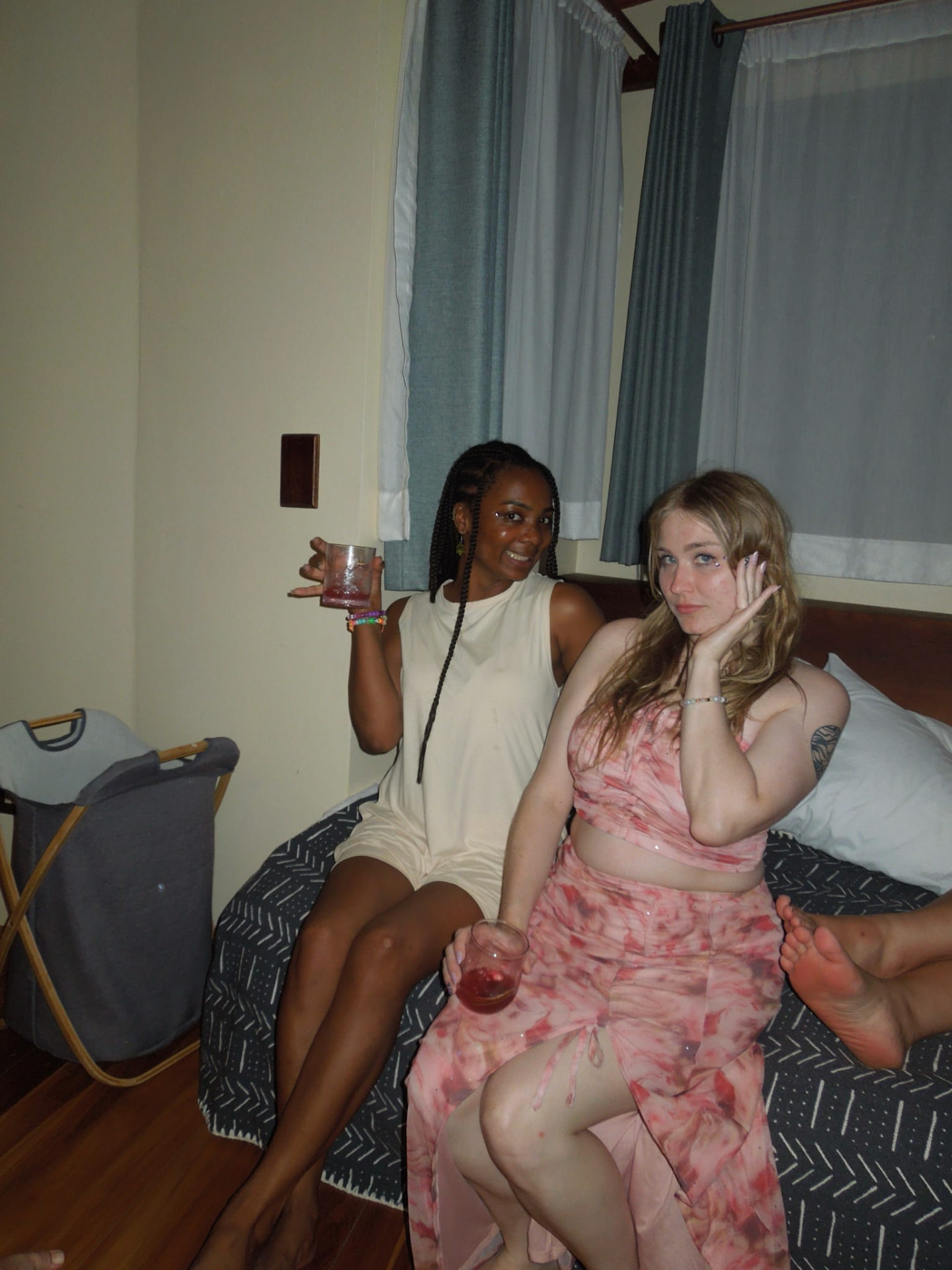 Two guests relaxing with drinks in their room before the party