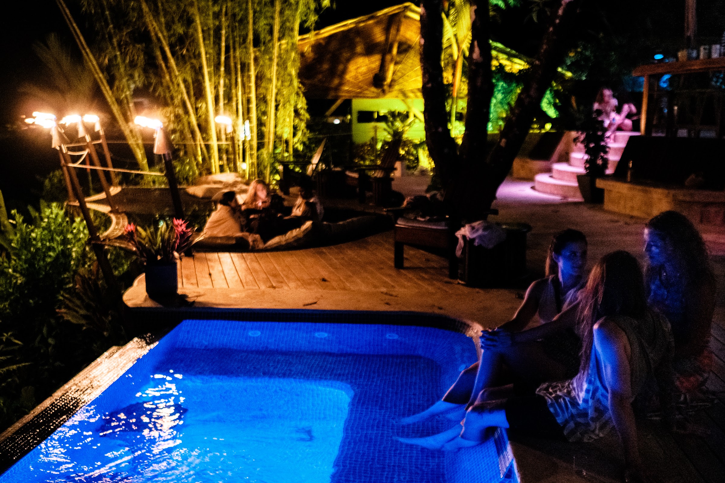 Night swim in the pool under lanterns