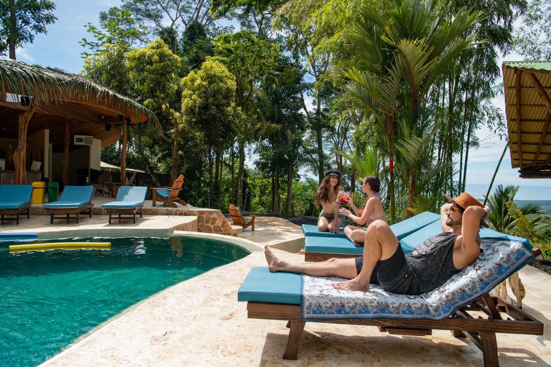 Friends hanging out and toasting by the pool