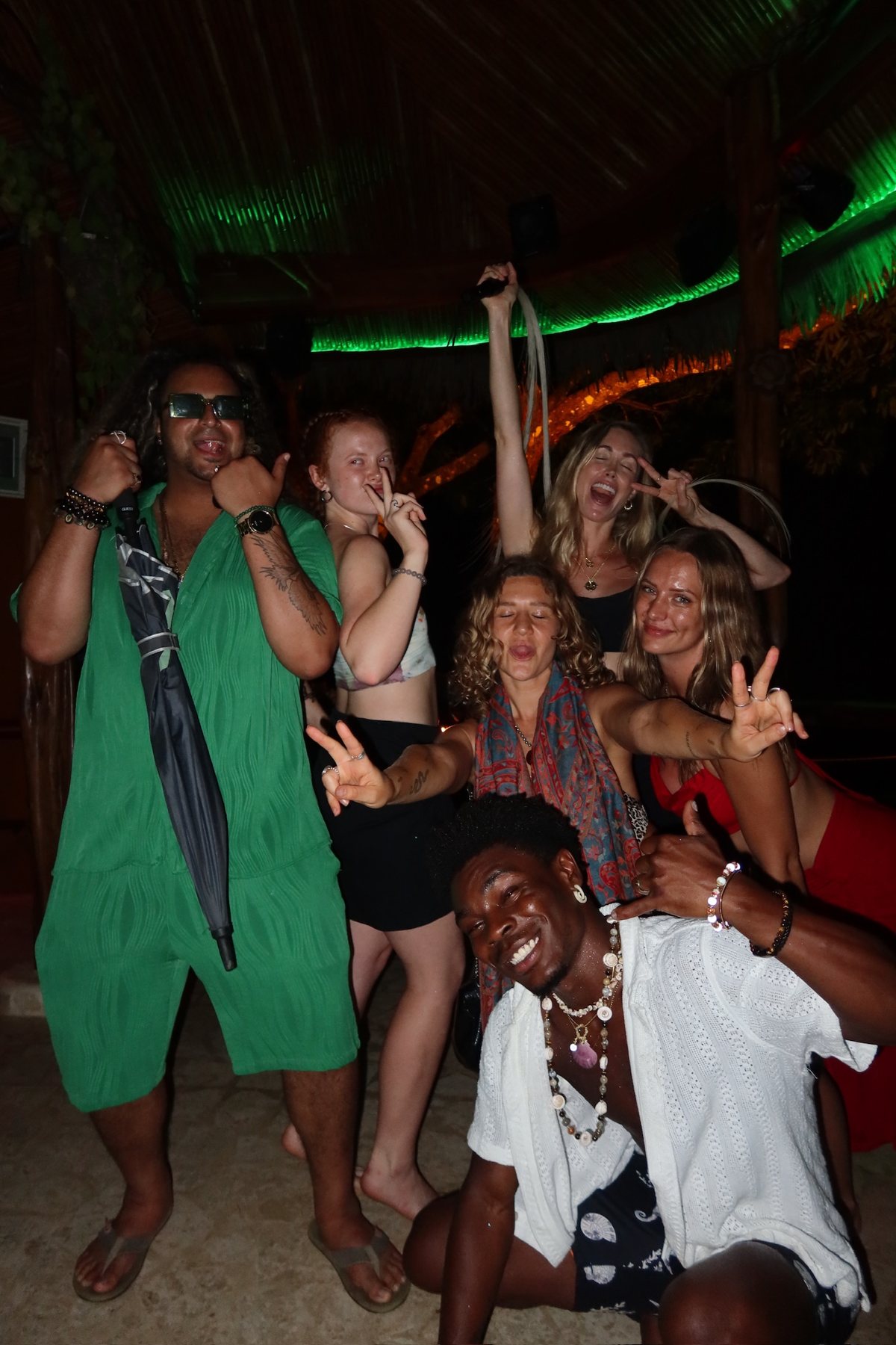 The whole crew dancing together at the party
