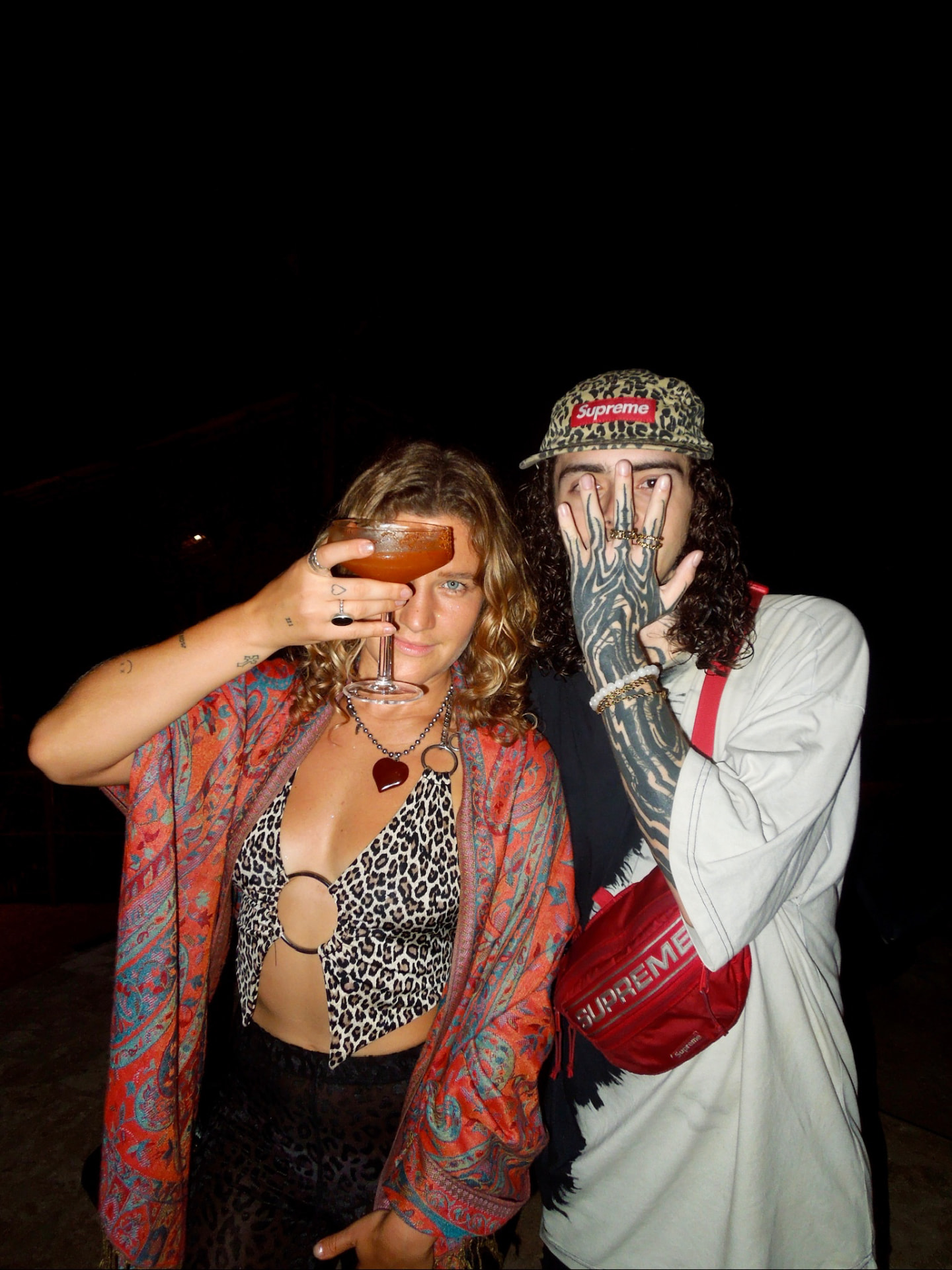 Two guests with drinks at the night party