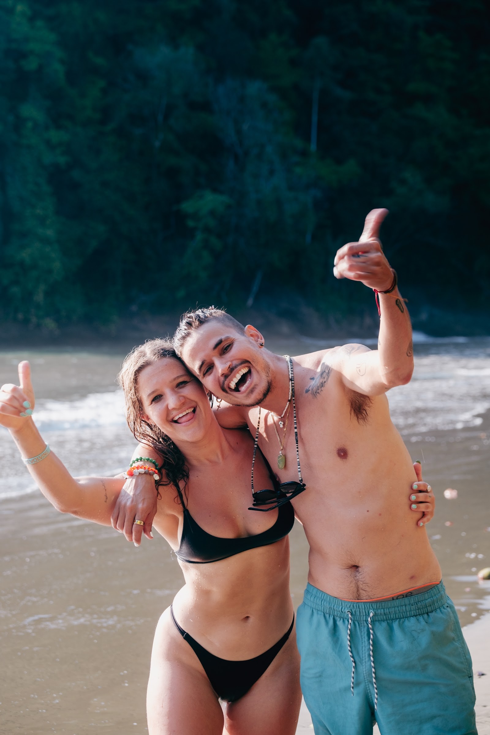 Two friends goofing off on the beach at low tide