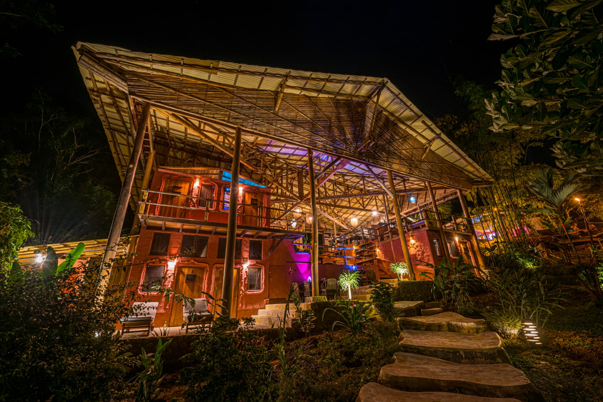 Casa Grande lit up in orange and violet light at night