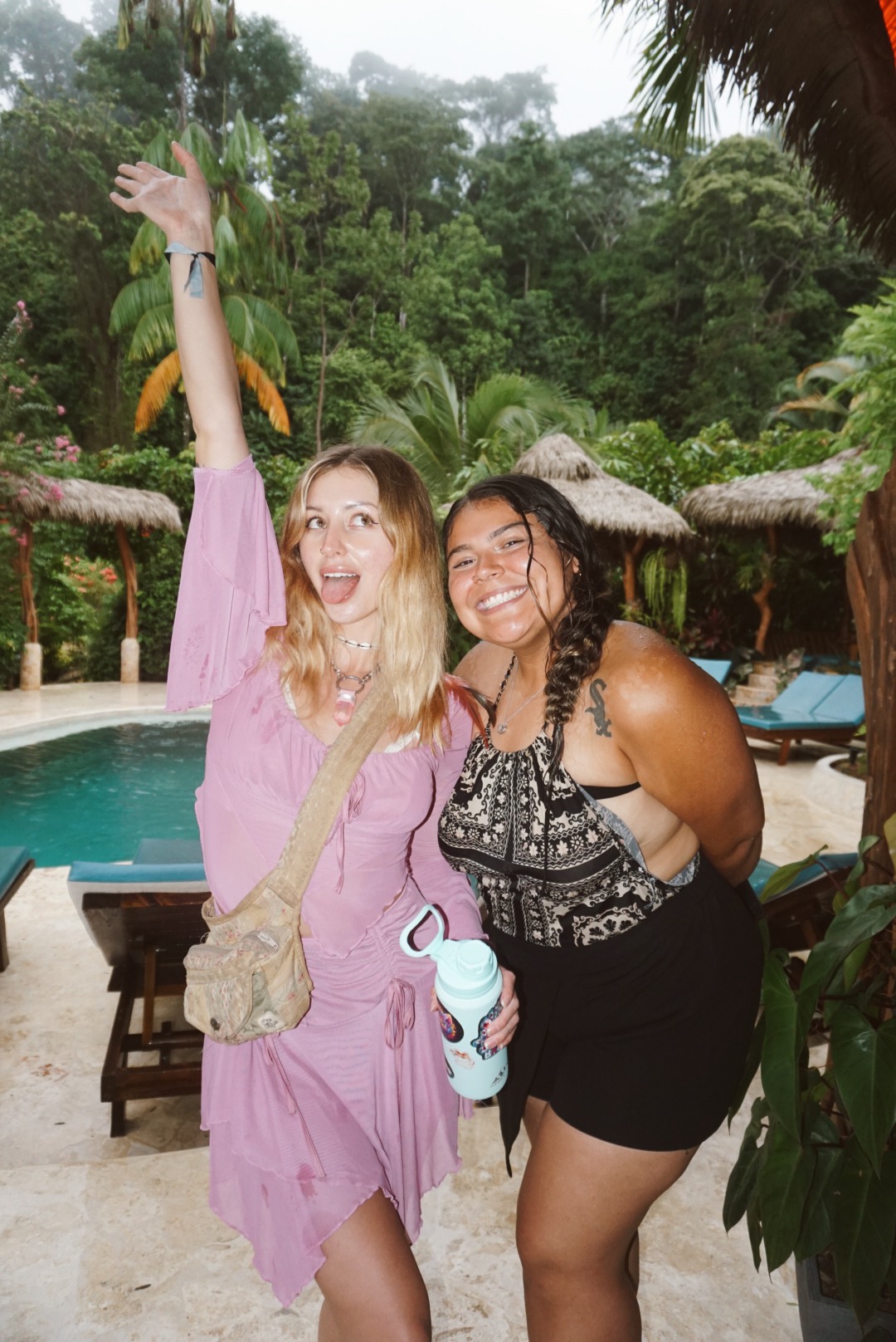 Two friends celebrating beside the jungle pool