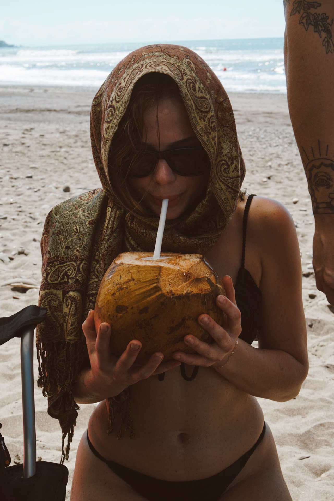 Sipping a fresh coconut on the beach in Costa Rica