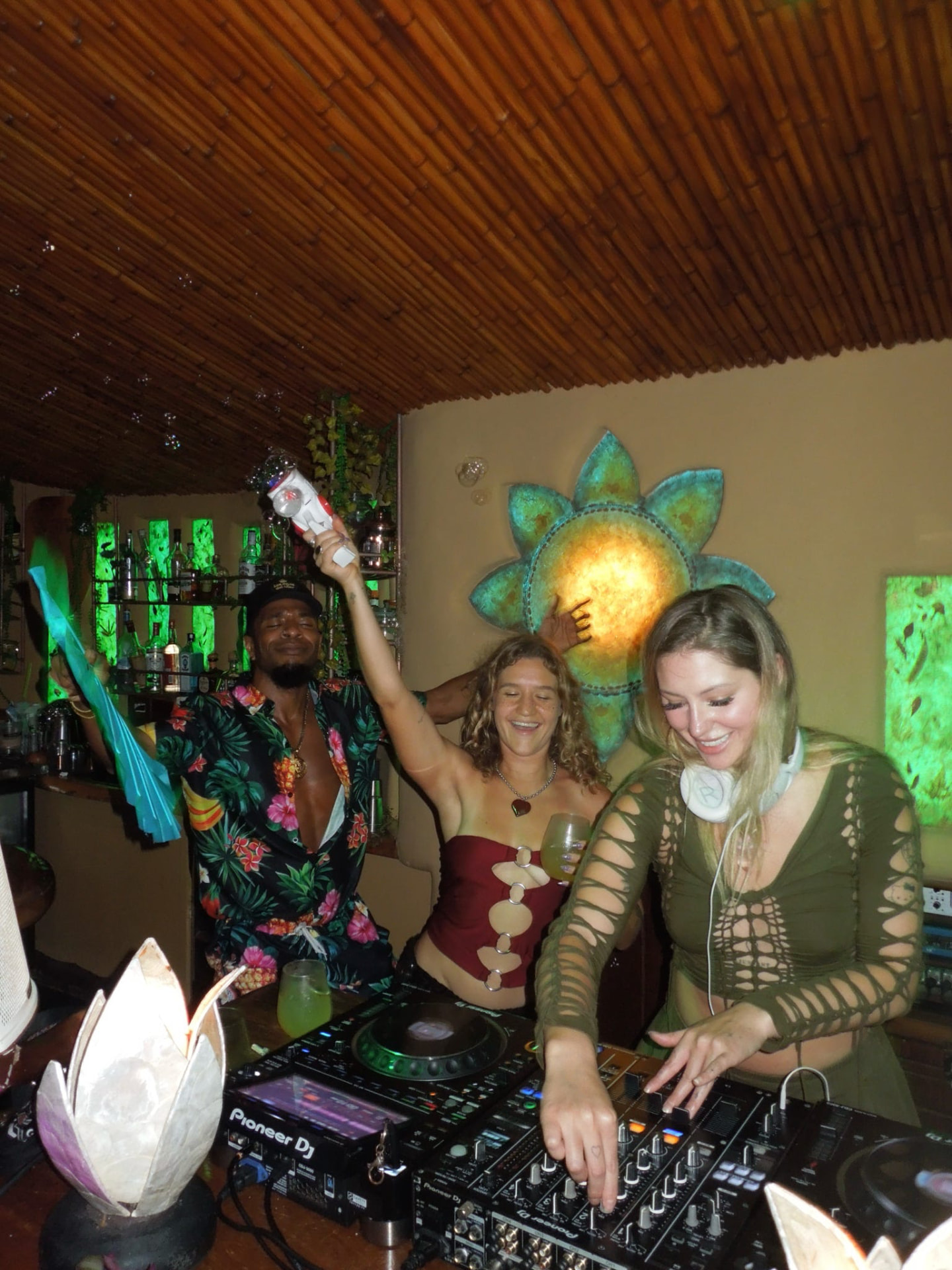 Bianca DJing with a bubble gun while friends dance behind her