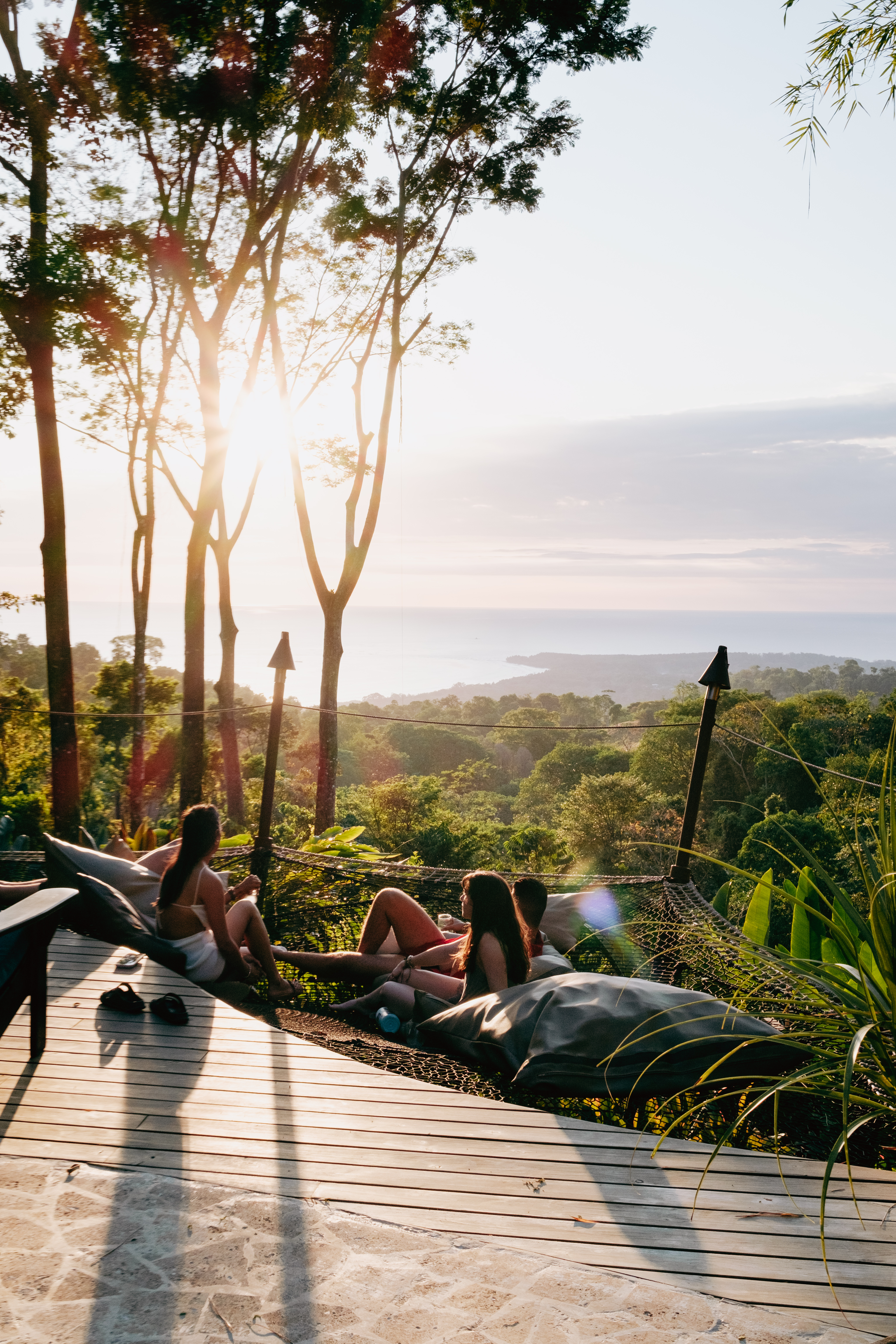 Loungers on the deck in golden light above the ocean