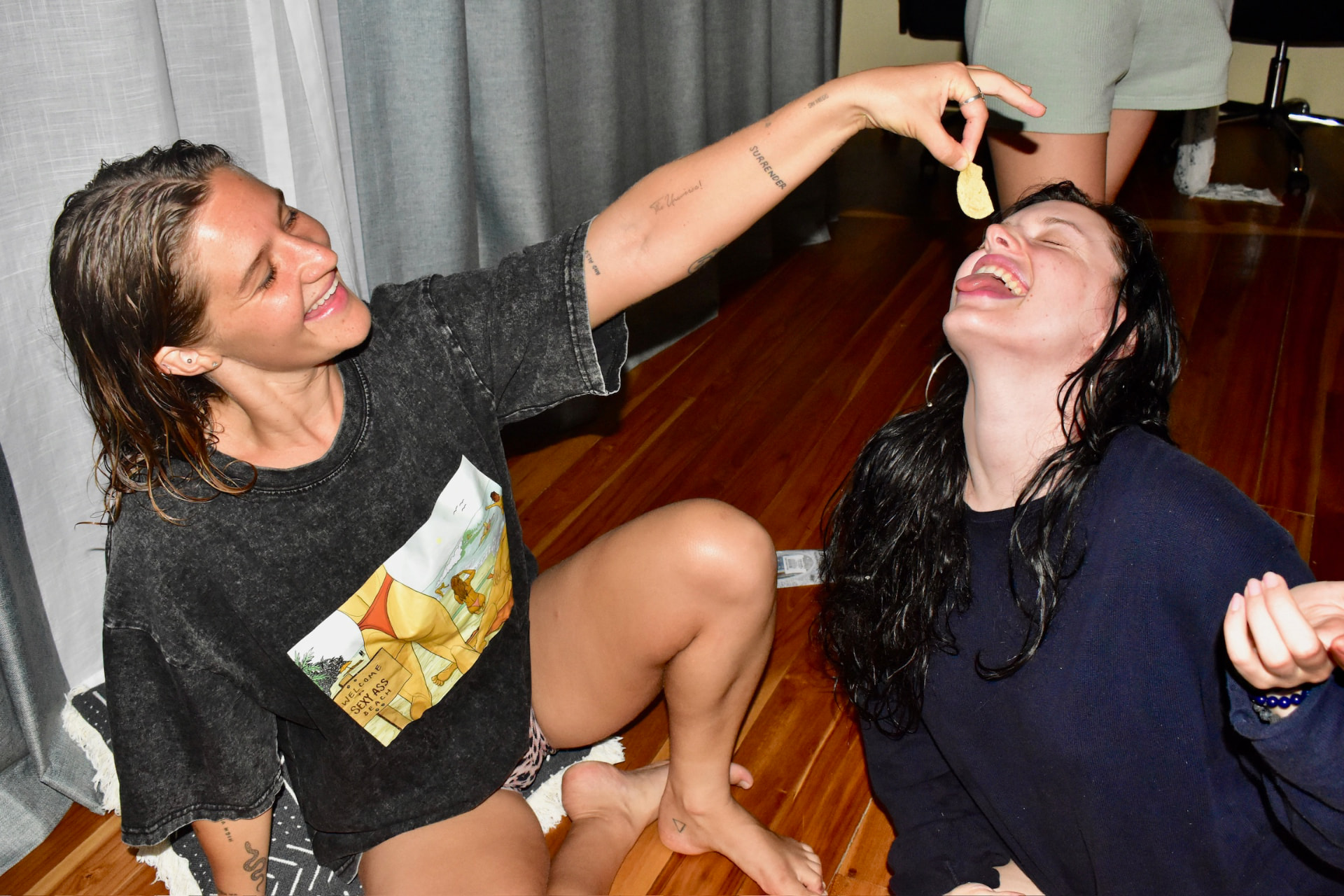 Friends laughing and sharing snacks in the bungalow